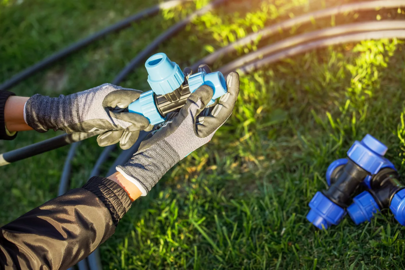 Technician connecting irrigation pipe fittings.